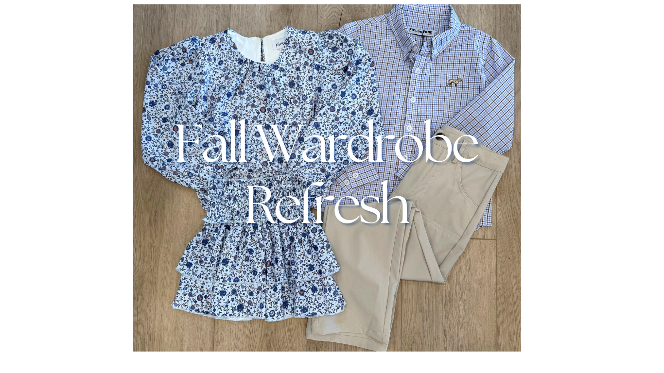 Fall wardrobe refresh with a floral blouse, checkered shirt, and beige pants on a wooden surface.